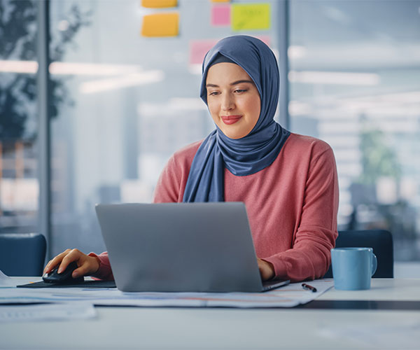 young muslim businesswoman using a laptop